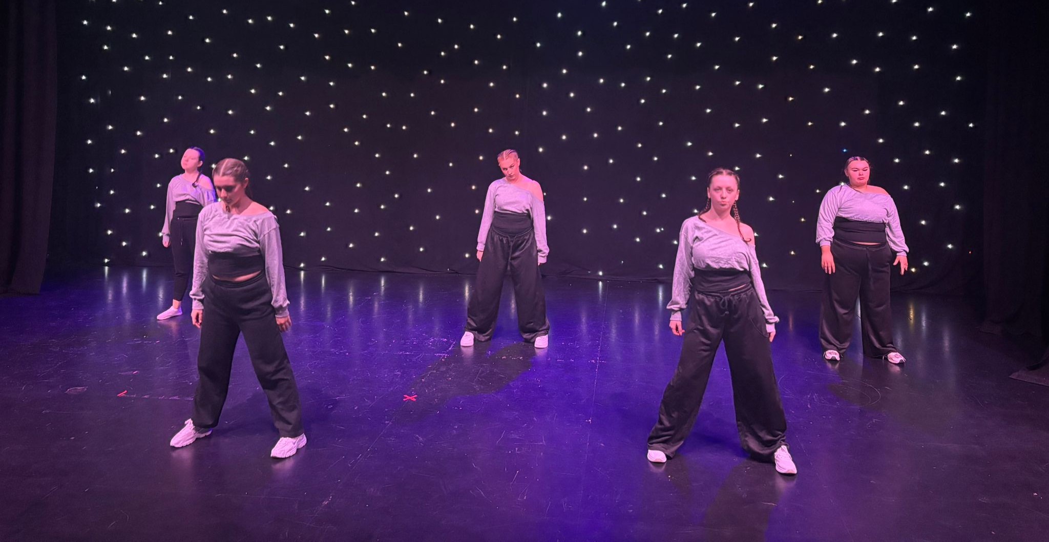 Smiling dancers on stage during show in Bradford