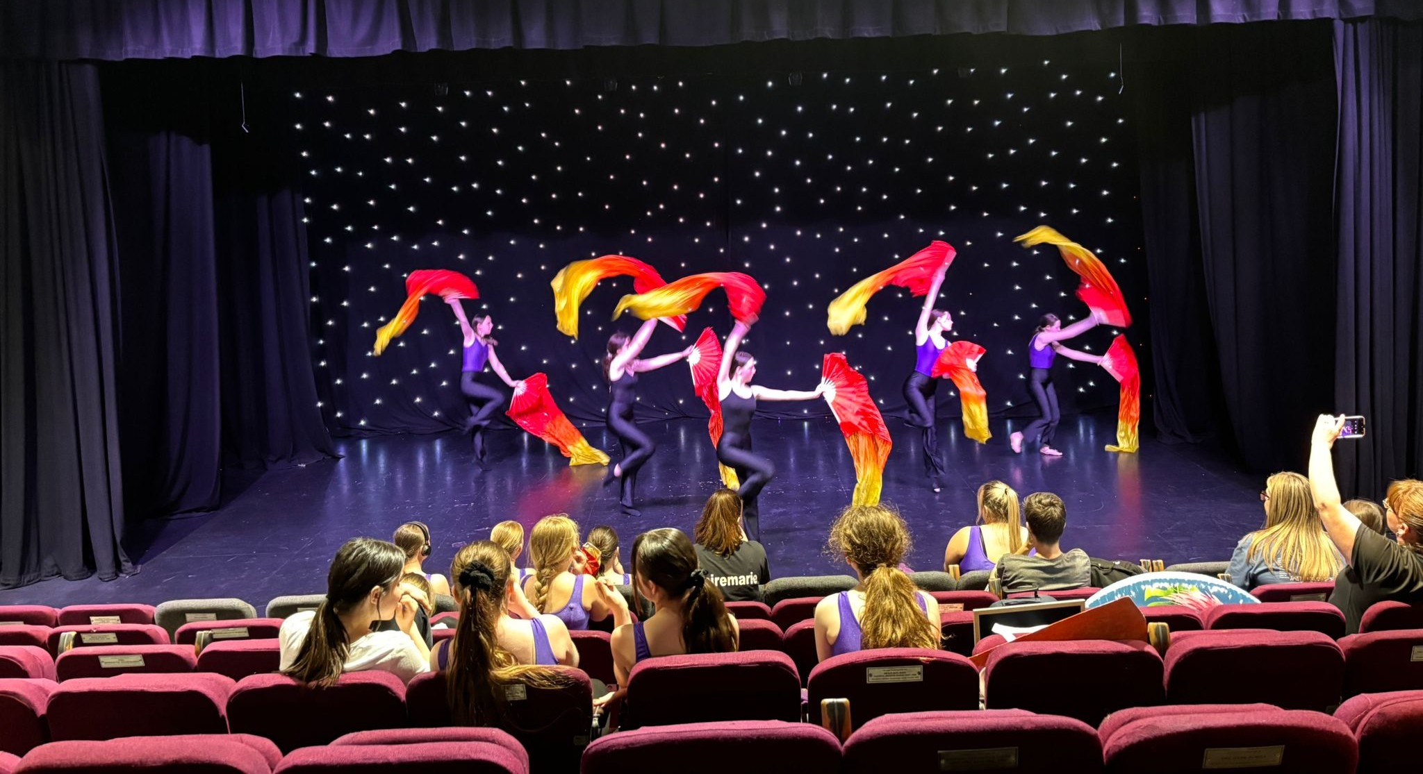 Students performing colourful group routine at Clairemarie’s annual show